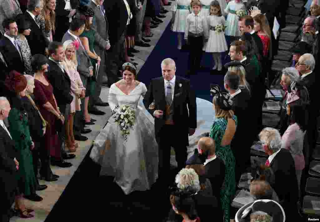 Princess Eugenie walks down the aisle with her father, the Duke of York, for her wedding to Jack Brooksbank at St George's Chapel in Windsor Castle, Windsor, Britain, Oct. 12, 2018. 