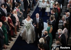 Princess Eugenie walks down the aisle with her father, the Duke of York, for her wedding to Jack Brooksbank at St George's Chapel in Windsor Castle, Windsor, Britain, Oct. 12, 2018.