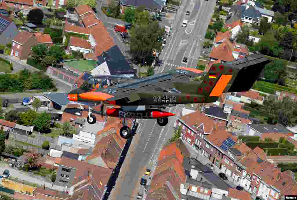 An OV-10 Bronco aircraft, decorated with World War I commemoration motifs, flies over Flanders international airport, ahead of the world&#39;s first Short Take Off &amp; Landing competition on sand, in Wevelgem, Belgium.