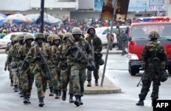 FILE - Liberian army soldiers walk on the Monrovia bridge during a training excercise as the United Nations Mission in Liberia forces (UNMIL) finally hands back security to Liberia's military and police, in Monrovia on June 24, 2016.