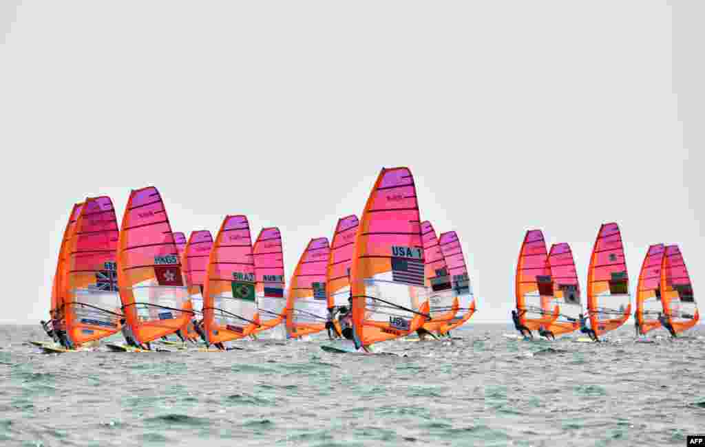 Athletes take part in the women&#39;s windsurfing RS:X class competition during a sailing test event for the Tokyo 2020 Olympic Games, off the coast Enoshima in Kanagawa Prefecture, Japan.