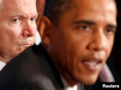 President Barack Obama speaks as then Secretary of Defense Robert Gates (L) listens during a cabinet meeting in the Cabinet Room of the White House on June 22, 2010.