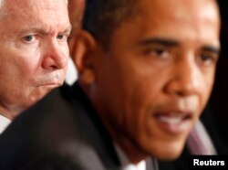 President Barack Obama speaks as then Secretary of Defense Robert Gates (L) listens during a cabinet meeting in the Cabinet Room of the White House on June 22, 2010.