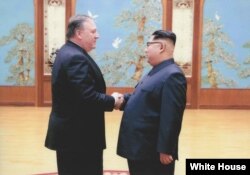 FILE - In this image released by the White House, then-CIA director Mike Pompeo shakes hands with North Korean leader Kim Jong Un in Pyongyang, North Korea, during a 2018 East weekend trip.