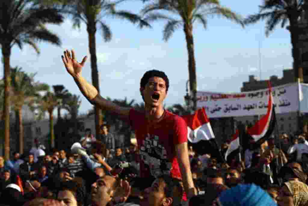 Protesters chant slogans as they march following an attack by security forces in Tahrir Square, in Cairo, Egypt, Saturday, April 9, 2011