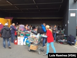 Austrian volunteers deliver food to arriving refugees in Vienna, Sept. 6, 2015.