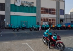 Delivery drivers for Deliveroo wait for orders, in Dubai, United Arab Emirates, Thursday, Sept. 9, 2021. Increasing online delivery orders has changed the city of Dubai. (AP Photo/Jon Gambrell)