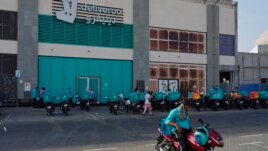 Delivery drivers for Deliveroo wait for orders, in Dubai, United Arab Emirates, Thursday, Sept. 9, 2021. Increasing online delivery orders has changed the city of Dubai. (AP Photo/Jon Gambrell)