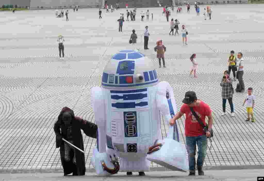 A Star Wars fan, dressed as R2D2 robot, arrives during the annual Star Wars Day in Taipei, Taiwan.