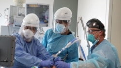 Dr. Dan Ponticiello, 43, and Dr. Gabriel Gomez, 40, intubate a coronavirus disease (COVID-19) patient in the COVID-19 ICU at Providence Mission Hospital in Mission Viejo, California, U.S., January 8, 2021.