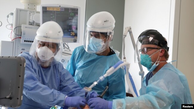 Dr. Dan Ponticiello, 43, and Dr. Gabriel Gomez, 40, intubate a coronavirus disease (COVID-19) patient in the COVID-19 ICU at Providence Mission Hospital in Mission Viejo, California, U.S., January 8, 2021.