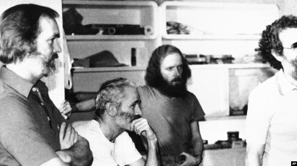 FILE - Four American hostages held in Iran listen to the latest demands for their release on Dec. 25, 1980. From left: William Belk of Columbia, S. C.; Thomas Schaefer of Tacoma, Wash.; Donald Hohman of West Sacramento, Calif.; and John Craves of Reston, 