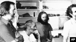 FILE - Four American hostages held in Iran listen to the latest demands for their release on Dec. 25, 1980. From left: William Belk of Columbia, S.C.; Thomas Schaefer of Tacoma, Wash.; Donald Hohman of West Sacramento, Calif.; and John Craves of Reston, Va.