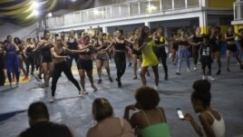 In this Jan. 15, 2020 photo, performers of the Paraiso do Tuiuti samba school practice in Rio de Janeiro, Brazil. (AP Photo/Silvia Izquierdo)