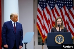 U.S President Donald Trump watches U.S. Court of Appeals for the Seventh Circuit Judge Amy Coney Barrett deliver remarks as he holds an event to announce her as his nominee to fill the Supreme Court seat left vacant by the death of Justice Ruth Bader Gins