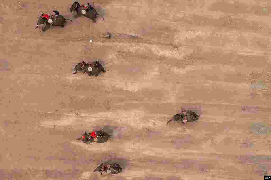 This aerial photograph shows mahouts racing their elephants during the Buon Don elephant festival in Vietnam&#39;s central highlands of Dak Lak province.