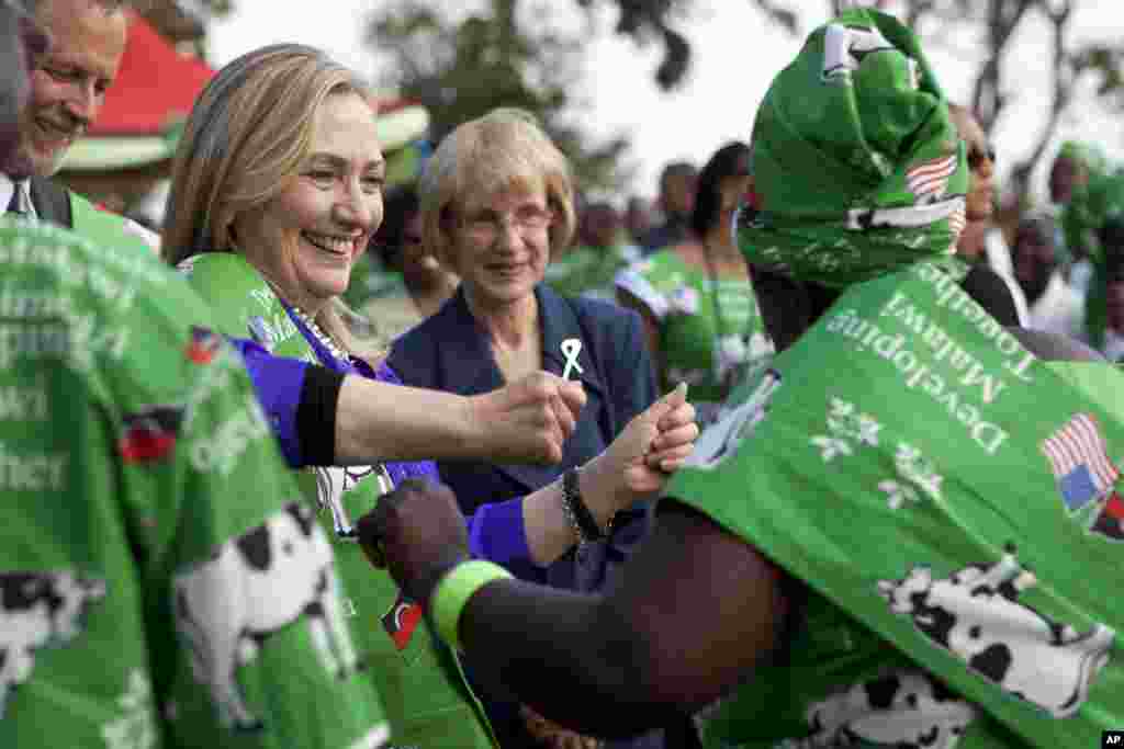 Hillary Clinton dances with Emille Phiri, chair of the Lumbadzi Milk Bulking Group, Lilongwe, Malawi, August 5, 2012.