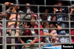 FILE - A group of Myanmar refugees are seen on a pick-up truck in Mae Sot, Thailand.