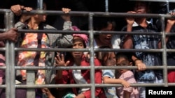 FILE - A group of Myanmar refugees are seen on a truck in Mae Sot, Thailand.