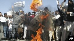 Afghans burn the U.S. flag in Herat, west of Kabul, Afghanistan, Sept. 16, 2012, during a protest against an Internet video mocking the Prophet Muhammad.