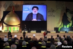 FILE - Lebanon's Hezbollah leader Sayyed Hassan Nasrallah addresses his supporters in Lebanon. Saudi anger at the power of Iran-backed Hezbollah in Lebanon is growing, with Gulf governments labelling Hezbollah a "terrorist group" and placing sanctions on a number of companies and individuals accused of being Hezbollah affiliated.
