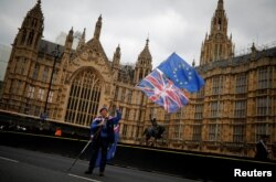An anti-Brexit protester stands outside Parliament, in London, March 27, 2019.