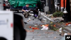 Evidence teams investigate at the scene of Saturday's explosion on West 23rd Street in Manhattan's Chelsea neighborhood in New York, Sept. 19, 2016. Ahmad Khan Rahami, a U.S. citizen of Afghan descent has been charged in the bombing.