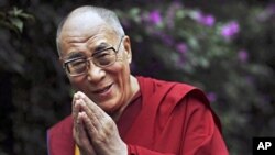 Tibetan spiritual leader the Dalai Lama smiles following an interview with AP outside his residence in Dharmsala, northern India. (file photo)