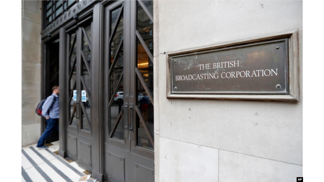 FILE - A man enters the headquarters building of the British Broadcasting Corporation (BBC), in London, Britain, July 19, 2017.