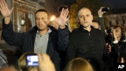 Alexei Navalny, a prominent anti-corruption whistle blower and blogger, left, and opposition leader Sergei Udaltsov, address protesters, Moscow, May 8, 2012.