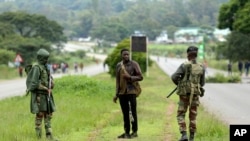 Soldiers patrol the streets as protestors gather during a demonstration over the hike in fuel prices in Harare, Zimbabwe, Tuesday, Jan. 15, 2019. 