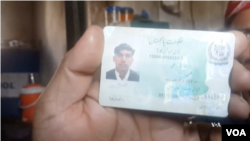 An ethnic Pashtun shows his ID card in Bajaur, Pakistan. Pashtuns say they are being harassed by police and undergoing racial profiling.