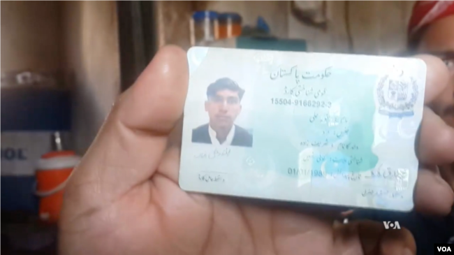 An ethnic Pashtun shows his ID card in Bajaur, Pakistan. Pashtuns say they are being harassed by police and undergoing racial profiling.