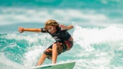 Ravi Hadad, 11, rides a wave during a local surf tournament at Maresias beach, in Sao Sebastiao, Brazil, Nov. 27, 2021.