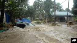 A car is submerged as roads and houses are engulfed in water following heavy rain and landslide in Kozhikode, Kerala state, India, Aug. 9, 2018. 