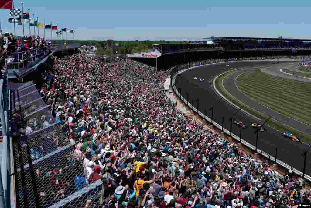 Spectators react as drivers take their first lap at the Indy 500, the largest attended sporting event since the start of the coronavirus disease (COVID-19) pandemic, in Indianapolis, Indiana, May 30, 2021.