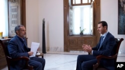 This photo released by the Syrian official news agency SANA, shows Syrian President Bashar Assad speaking during an interview with Iran's Khabar TV, in Damascus, Syria, Sunday, Oct. 4, 2015. 