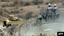 Members of the Saudi border guard and army's armored personnel carrier (APC) patrol the Saudi-Yemeni border, in southwestern Saudi Arabia, April 9, 2015. 