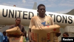 FILE - Donated food is unloaded in Haiti. 