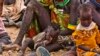 FILE - Women and their children wait to receive relief food supplies near the Kakuma Refugee Camp, northwest of Kenya's capital Nairobi, August 8, 2011. Aid agencies and the Kenyan government set up a new settlement for refugees about 30 kilometers away, in the northwestern town of Kalobeyei, last year.