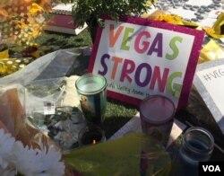 Sign seen at makeshift memorial for victims of mass shooting in Las Vegas on Sunday, Oct. 2 that killed 58 people. (Photo: C. Presutti / VOA)