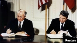FILE - U.S. President Ronald Reagan (R) and Soviet President Mikhail Gorbachev sign the Intermediate-Range Nuclear Forces (INF) treaty in the White House, Dec. 8 1987.