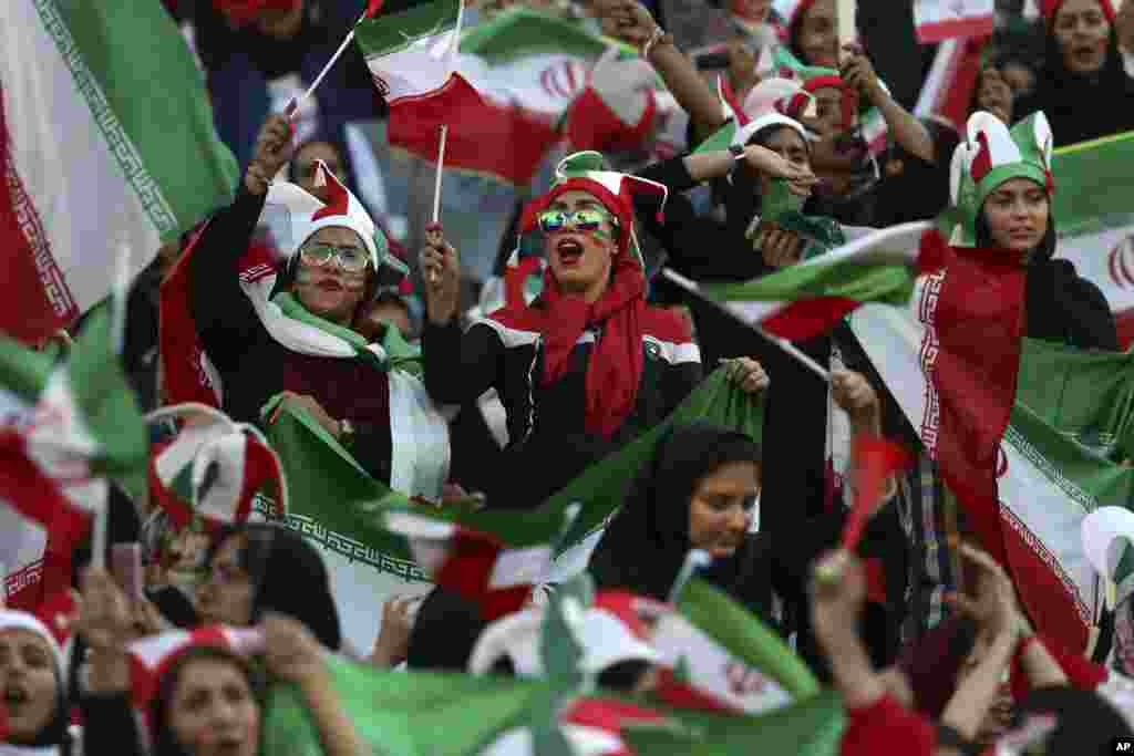 Iranian women cheer during a soccer match between their national team and Cambodia in the 2022 World Cup qualifier at the Azadi (Freedom) Stadium in Tehran. Iranian women were freely allowed into the stadium for the first time in decades.