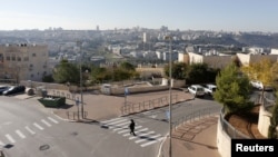 An ultra-Orthodox Jewish man walks in Ramat Shlomo, a religious Jewish settlement in an area of the occupied West Bank, in East Jerusalem, claimed by both Israel and Palestinians, December 18, 2012.