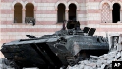 A damaged Syrian military tank is seen at the border town of Azaz, about 20 miles north of Aleppo, Syria, July 24, 2012.