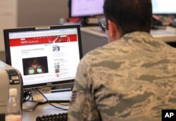 FILE - A staff member checks a news site at the NATO Computer Incident Response Capability (NCIRC) technical center, at NATO's military headquarters SHAPE in Mons, southwestern Belgium, Tuesday, Dec. 10, 2013.