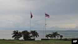 Cambodian and Thai flag poles on the Gulf of Thailand at Koh Kong-Trat border crossing between the two countries. The new visa exemption agreement raises hopes of increased trade and tourism between the two neighbors.