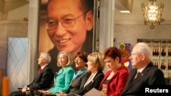 The Norwegian Nobel committee consisting of chairman Thorbjoern Jagland, Kaci K. Five, Sissel Roenbeck, Inger-Marie Ytterhorn, Aagot Valle and committee secretary Geir Lundestad (L-R) sit during the Nobel Peace Prize ceremony.