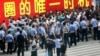 Chinese police face off with a group of Africans blocking the entrance to the police station in Guangzhou, in southern China's Guangdong province, July 15, 2009. 