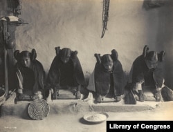 This 1906 photo by Edward S. Curtis shows Hopi women grinding grain into flour.